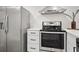 View of stainless steel refrigerator, white cabinets, range and stainless steel hood at 5954 Crestview Ave, Indianapolis, IN 46220