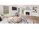 Elegant living room featuring hardwood floors, a fireplace, and large windows, offering a cozy and well-lit ambiance at 5954 Crestview Ave, Indianapolis, IN 46220