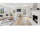 Open-concept living room with large windows, a fireplace, and a cozy seating area at 5954 Crestview Ave, Indianapolis, IN 46220
