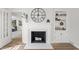 Close up of a fireplace in a living room with a large clock, mantle, and shelving at 5954 Crestview Ave, Indianapolis, IN 46220