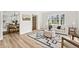 Bright living room with hardwood floors, a comfortable sofa, and an ottoman, creating an inviting space at 5954 Crestview Ave, Indianapolis, IN 46220