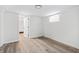 Unfurnished room with light wood flooring, neutral walls, a glass block window, and an open doorway at 5954 Crestview Ave, Indianapolis, IN 46220