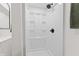 Bright white shower stall featuring a sleek black shower head and convenient built-in shelving at 5954 Crestview Ave, Indianapolis, IN 46220