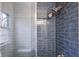 This shower features blue tiled walls and a multi head shower system at 5954 Crestview Ave, Indianapolis, IN 46220