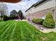 Well-maintained backyard featuring lush green grass, landscaping and patio at 5983 Clearview Dr, Carmel, IN 46033