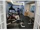 Home gym in finished basement with rubber flooring and blue accent wall at 5983 Clearview Dr, Carmel, IN 46033