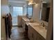 Bright and modern bathroom with double vanities, frameless shower, and contemporary fixtures at 5983 Clearview Dr, Carmel, IN 46033