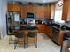 Kitchen featuring stainless steel appliances, island with seating, and light wood cabinets at 5983 Clearview Dr, Carmel, IN 46033