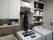 Bright laundry room includes modern appliances and plenty of shelving for storage solutions at 5983 Clearview Dr, Carmel, IN 46033