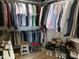 This walk-in closet boasts ample storage space with hanging racks and shelves for organization at 5983 Clearview Dr, Carmel, IN 46033