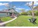 Expansive backyard with patio furniture, lawn and a glimpse of the home's attractive exterior at 6185 Evanston Ave, Indianapolis, IN 46220