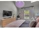 Bright bedroom featuring plush bedding, skylights, view of backyard, dresser and decor at 6185 Evanston Ave, Indianapolis, IN 46220