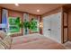 Bedroom featuring natural light, a large plant, and a view of the green backyard at 6185 Evanston Ave, Indianapolis, IN 46220