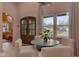 Bright breakfast nook with wood door, lots of natural light, and seating for four at 6185 Evanston Ave, Indianapolis, IN 46220