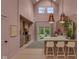Open kitchen area with stainless appliances, a large island with seating, and a view of the bright backyard at 6185 Evanston Ave, Indianapolis, IN 46220
