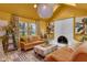 Stylish living room with yellow walls, skylight, fireplace, and comfortable seating at 6185 Evanston Ave, Indianapolis, IN 46220