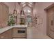 Open-concept living space with a statement lighting, lots of natural light, and access to the kitchen at 6185 Evanston Ave, Indianapolis, IN 46220