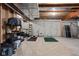 Unfinished basement area with shelves, storage containers, a ladder, and a workout area at 6645 Braemar N Ave, Noblesville, IN 46062