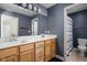 Bright bathroom with double sinks, classic cabinets, and a separate shower and toilet area at 6645 Braemar N Ave, Noblesville, IN 46062