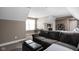 Cozy bedroom with a brown sofa, ottoman, a desk with a TV, and comfortable bed at 6645 Braemar N Ave, Noblesville, IN 46062