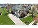 Stunning two-story home featuring a brick and siding facade, manicured lawn, and a three-car garage at 6645 Braemar N Ave, Noblesville, IN 46062