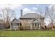 Back exterior of a brick and grey home with a large manicured lawn and mature landscaping at 6645 Braemar N Ave, Noblesville, IN 46062