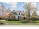 Beautiful home featuring brick and gray siding, a manicured lawn, and mature trees at 6645 Braemar N Ave, Noblesville, IN 46062