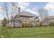 Rear exterior of a brick and grey house with a gabled roof, green lawn, and mature trees at 6645 Braemar N Ave, Noblesville, IN 46062