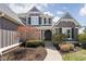 Inviting home exterior with gray siding, a brick accent wall, and a welcoming entrance at 6645 Braemar N Ave, Noblesville, IN 46062