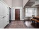 Elegant foyer features a wood door, high ceilings, dark floors, and a decorative area rug at 6645 Braemar N Ave, Noblesville, IN 46062