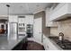 Spacious kitchen with stainless steel appliances, white cabinets, and a modern island at 6645 Braemar N Ave, Noblesville, IN 46062