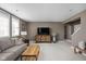 Inviting living room boasts natural light, a comfortable sofa, stylish decor, and a staircase at 6645 Braemar N Ave, Noblesville, IN 46062