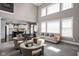 Bright living room featuring high ceilings, large windows, and a view of the open-concept kitchen at 6645 Braemar N Ave, Noblesville, IN 46062