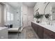 An elegant main bathroom features double vanities, stylish mirrors, and a spacious walk-in shower at 6645 Braemar N Ave, Noblesville, IN 46062