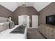 This main bedroom boasts high vaulted ceilings, a stylish chandelier, and ensuite access at 6645 Braemar N Ave, Noblesville, IN 46062