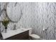 Striking powder room featuring patterned wallpaper, a floating vanity, and a decorative round mirror at 6645 Braemar N Ave, Noblesville, IN 46062