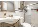 Bathroom featuring a white sink, tile floor, and glass-enclosed shower, offering a modern and clean space at 6911 N Tuxedo St, Indianapolis, IN 46220