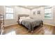 Inviting bedroom with natural light, hardwood floors, and a comfortable bed, creating a relaxing space at 6911 N Tuxedo St, Indianapolis, IN 46220
