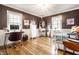 Bedroom featuring hardwood floors, a desk area, and a comfortable bed, creating a stylish and functional space at 6911 N Tuxedo St, Indianapolis, IN 46220