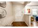 Bright entryway features hardwood floors, and neutral decor with decorative mirror at 6911 N Tuxedo St, Indianapolis, IN 46220