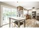 Sunlit kitchen featuring stainless steel appliances, tile floors, and a sliding glass door that leads to the pool area at 6911 N Tuxedo St, Indianapolis, IN 46220