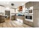 Charming kitchen features two-tone cabinets, subway tile backsplash, stainless steel appliances, and stylish tile floor at 6911 N Tuxedo St, Indianapolis, IN 46220