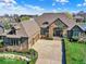 Expansive aerial view of a beautiful home with a stone and brown exterior and manicured landscaping at 7128 Trail Ridge Ln, Indianapolis, IN 46259