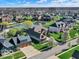 Panoramic aerial view of a community with a pond, lush greenery, and well-maintained homes at 7128 Trail Ridge Ln, Indianapolis, IN 46259