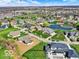 Expansive aerial view of a neighborhood featuring beautiful homes surrounding a tranquil lake at 7128 Trail Ridge Ln, Indianapolis, IN 46259