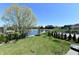 Expansive backyard view of a pond, lush landscaping, and other homes in the community at 7128 Trail Ridge Ln, Indianapolis, IN 46259