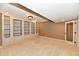 Basement room featuring built-in bookshelves and a doorway to another room at 7128 Trail Ridge Ln, Indianapolis, IN 46259