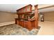 Basement bar area with dark wood cabinets and slate floors at 7128 Trail Ridge Ln, Indianapolis, IN 46259