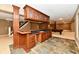 Basement wet bar featuring granite counters, wood cabinets, and slate floors at 7128 Trail Ridge Ln, Indianapolis, IN 46259