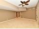 Finished basement room with carpet, ceiling fan, and access to other rooms at 7128 Trail Ridge Ln, Indianapolis, IN 46259